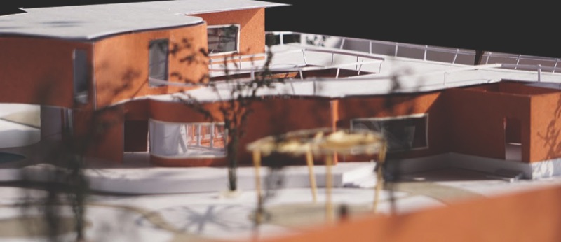 Card model of the house with a red upper volume
